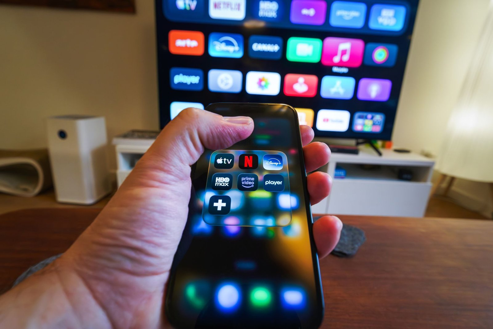 hand holding smartphone with streaming apps